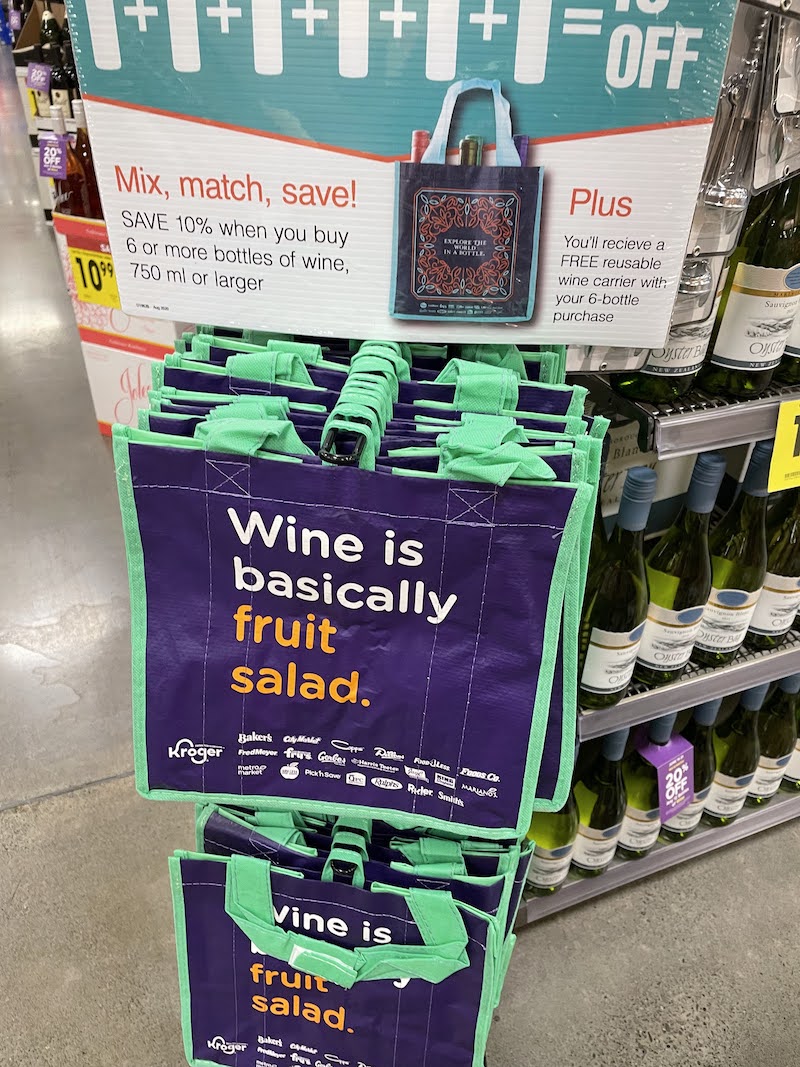 A bag at the store that reads "Wine is basically fruit salad"