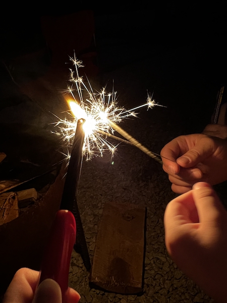 Some sparklers being lit on the fourth of July