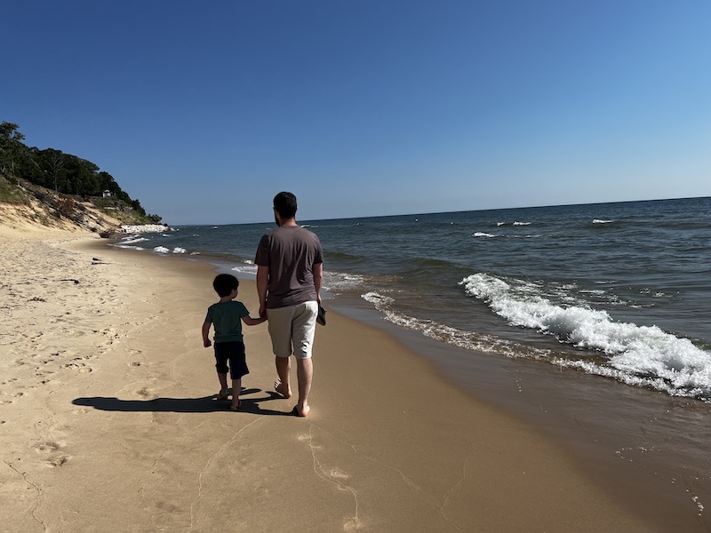 Me and my son walking on the beach of Lake Michigan