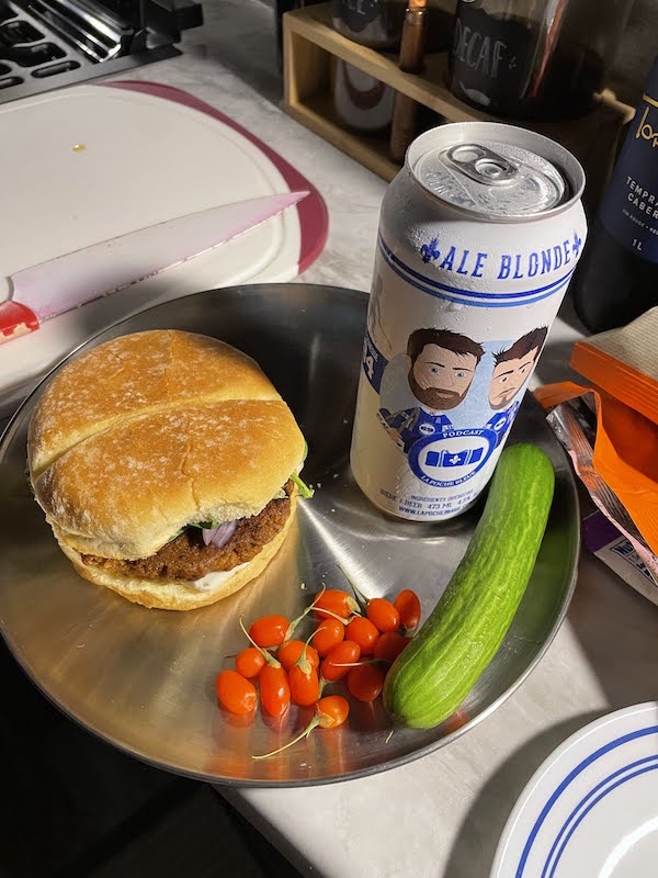 A vegan burger I made with some goji berries, a fresh cucumber, and a can of beer from Quebec