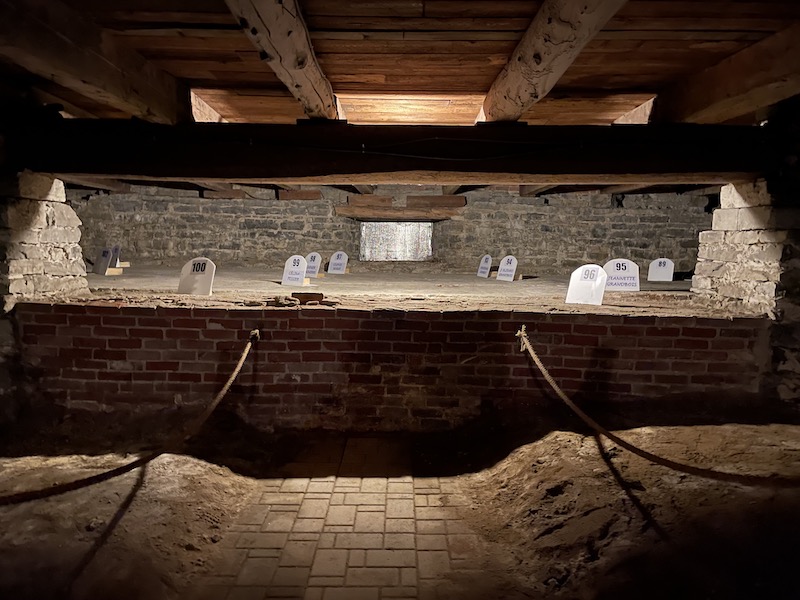 A crypt below the towering church just outside of Trois-Rivières, featuring singes where folks, some unnamed, have been buried