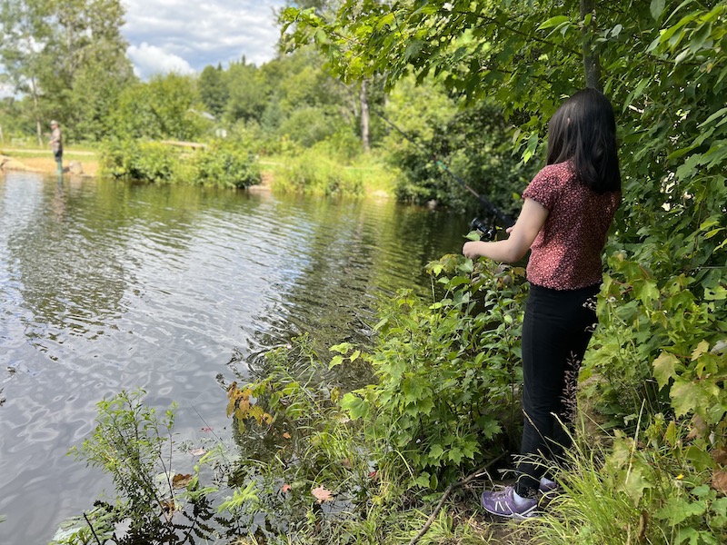 My daughter fishing from a pond