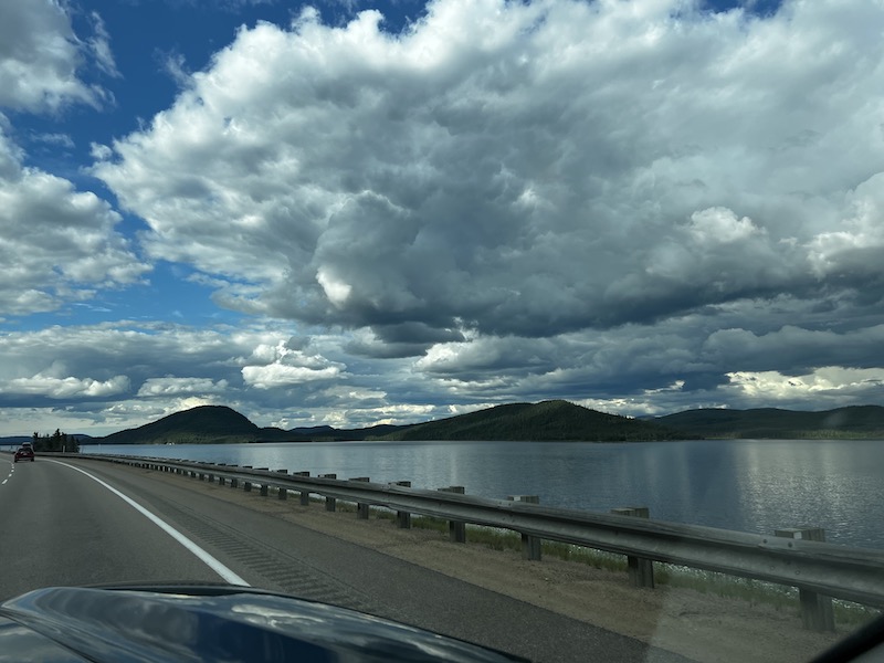 From the car of a lake and some evergreen covered hills