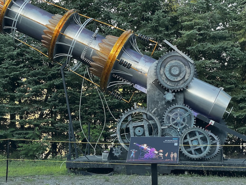 A large prop used in a play, now stationed outside for viewing, of a giant steampunk looking ray gun